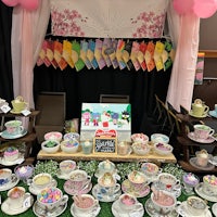 a display of tea cups and saucers on a table