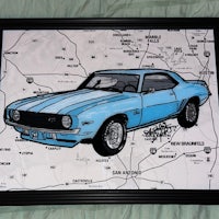 a blue chevrolet camaro framed in a frame