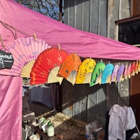 a group of colorful fans hanging from a tent