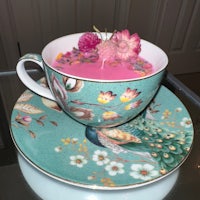 a teacup with pink flowers and a saucer