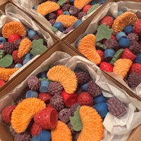a box of fruit shaped soaps sitting on a table