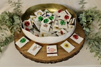 a bowl full of christmas cards on top of a wooden table