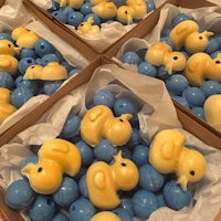 a box full of blue and yellow rubber ducks