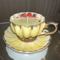 a candle in a teacup on a saucer