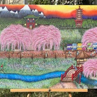 a painting of cherry blossoms on a easel